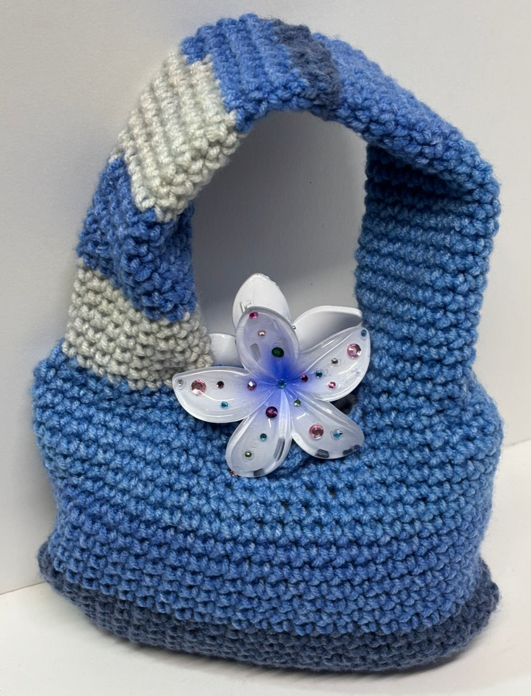 Blue handmade crochet handbag with a flower detail