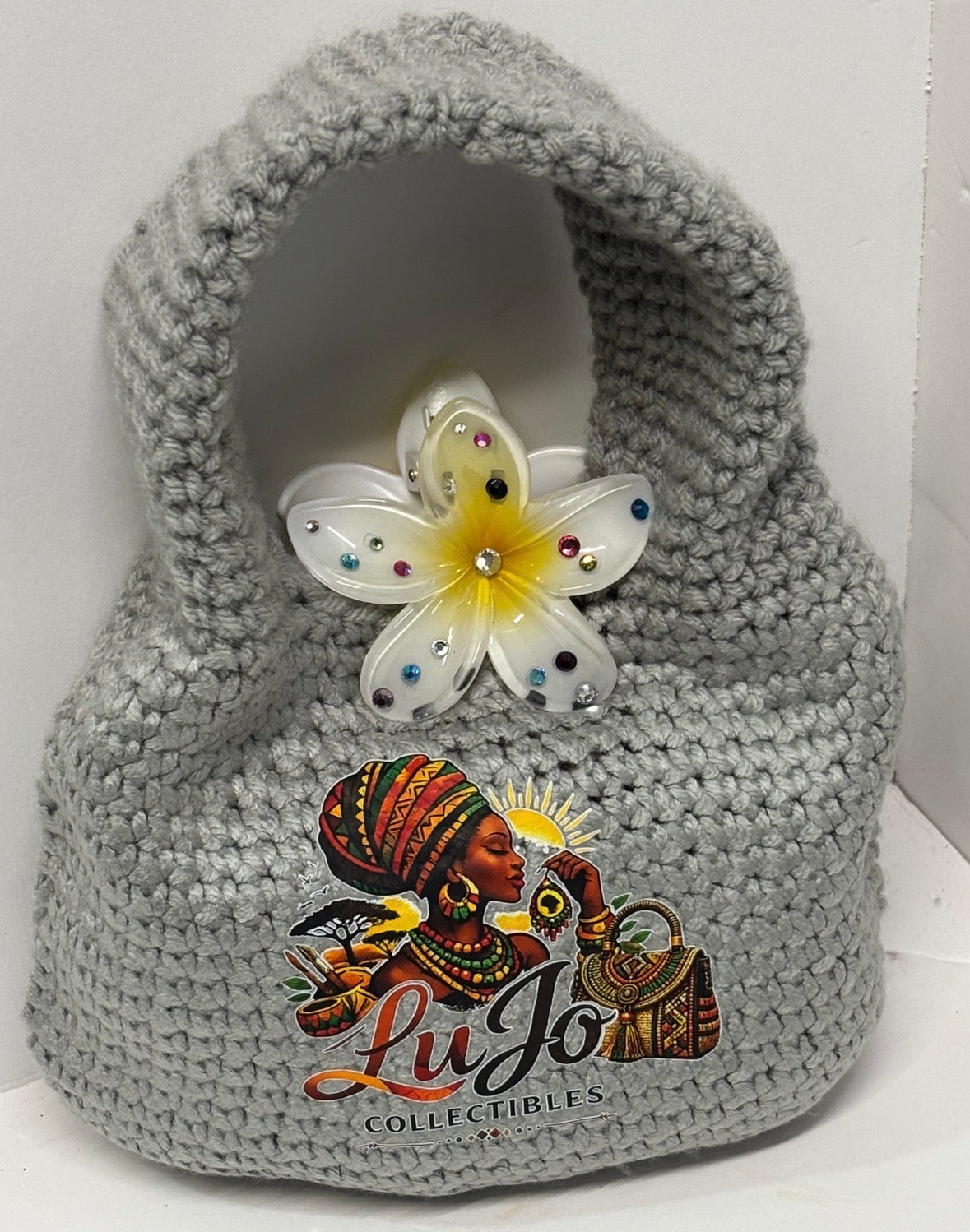 Grey handmade crochet handbag with a flower detail