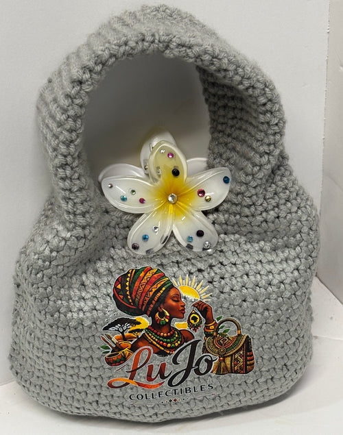Grey handmade crochet handbag with a flower detail