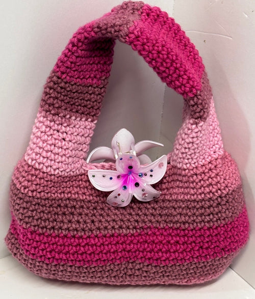 Pink handmade crochet handbag with a flower detail